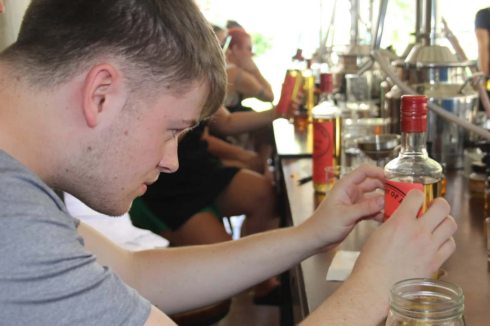 A guest working on his own rum bottle during the Academy of Rum Antigua class