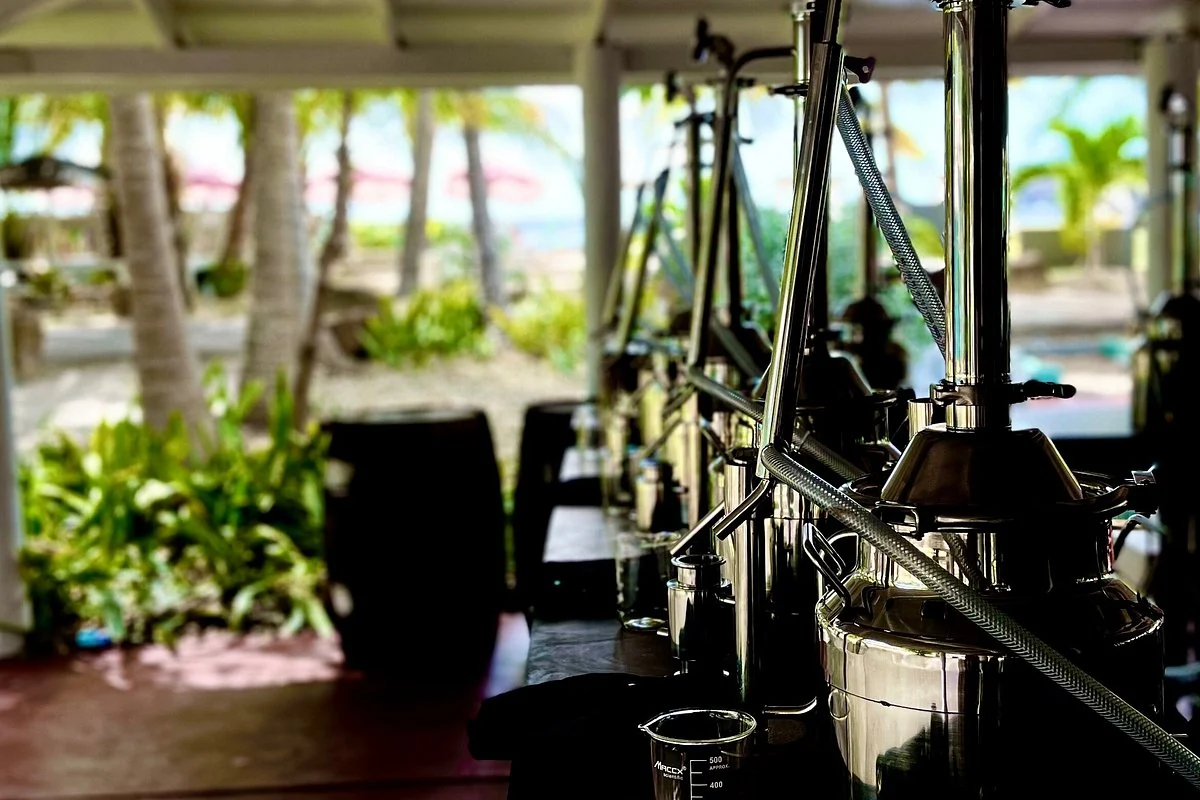 Tabletop stills overlooking Galleon Beach at the Academy of Rum mini distillery in Antigua